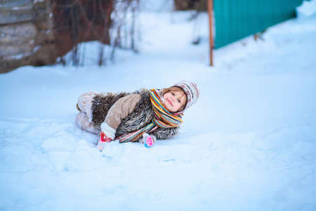 The girls playing with snow in winter.