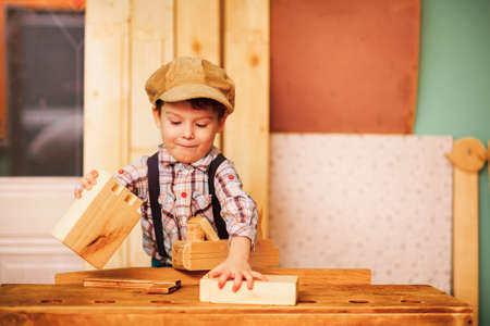The Boy working in a carpentry workshop.の写真素材