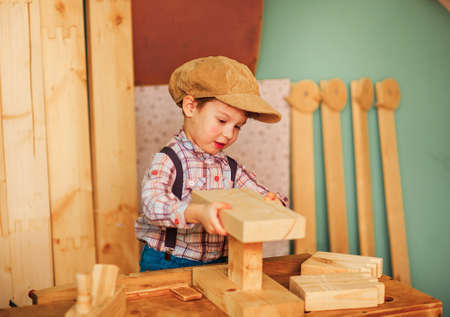 The Boy working in a carpentry workshop.の写真素材