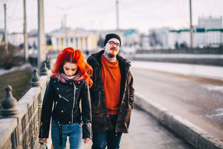 A loving young couple walks around the city.の写真素材