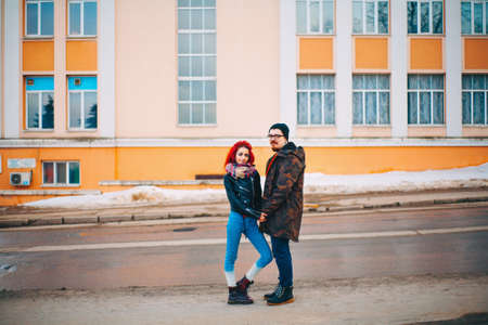 A loving young couple walks around the city.の写真素材