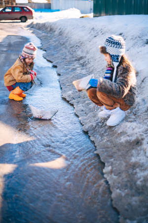 Little girls playing on the street in the village.の写真素材