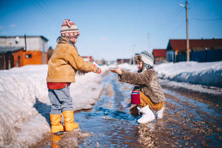 Little girls playing on the street in the village.の写真素材