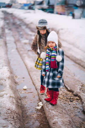 Little girls playing on the street in the village.の写真素材