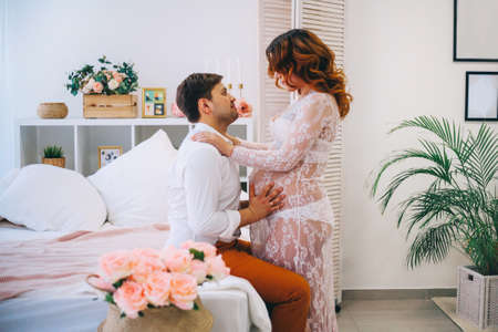 The Young pregnant woman in home interior.の写真素材