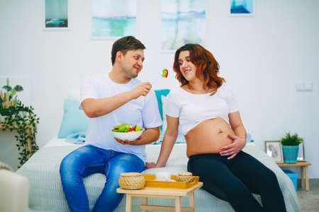 The Young pregnant woman in home interior.の写真素材