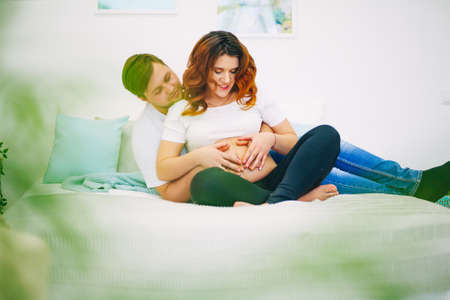 The Young pregnant woman in home interior.