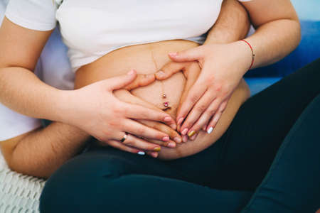 The Young pregnant woman in home interior.の写真素材