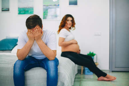 The Young pregnant woman in home interior.の写真素材