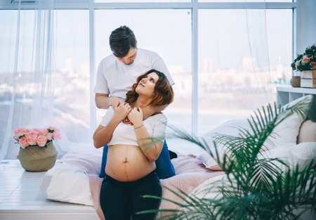 The Young pregnant woman in home interior.の写真素材