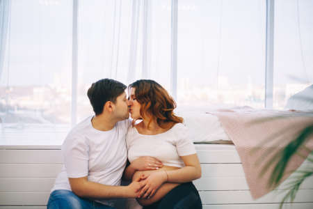 The Young pregnant woman in home interior.