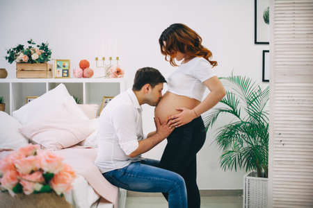 The Young pregnant woman in home interior.