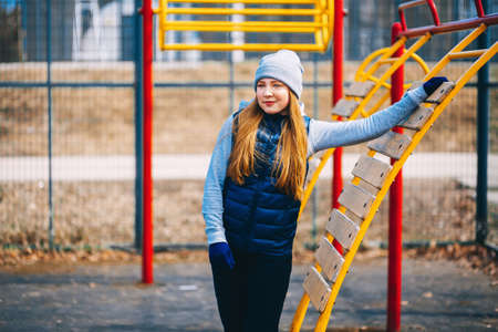 A young woman is engaged on a sports field.