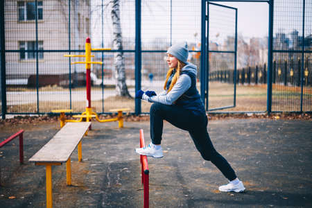 A young woman is engaged on a sports field.の写真素材