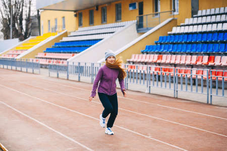 A young woman is engaged on a sports field.の写真素材