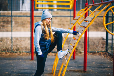 A young woman is engaged on a sports field.の写真素材