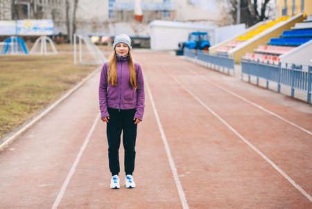 A young woman is engaged on a sports field.の写真素材