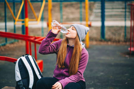 A young woman is engaged on a sports field.の写真素材