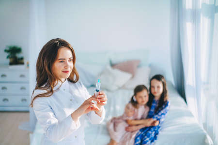 Little girls trust a young woman doctor.の写真素材