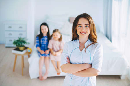 Little girls trust a young woman doctor.の写真素材