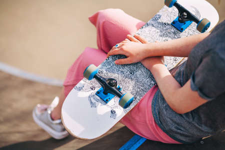 The Young woman portrait with a skateboard.の写真素材