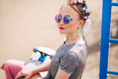 The Young woman portrait with a skateboard.の写真素材