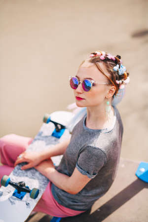 The Young woman portrait with a skateboard.の写真素材