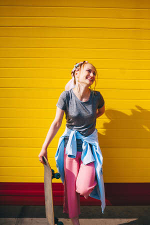 The Young woman portrait with a skateboard.の写真素材