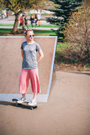 The Young woman portrait with a skateboard.の写真素材