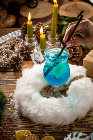 Blue lagoon cocktail with lemon on christmas decorated backgroundの写真素材
