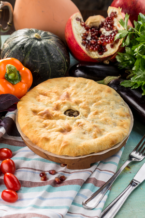 Traditional oriental cuisine Meat pie and fresh vegetables on textile napkin side viewの写真素材