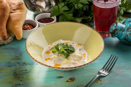 stew chicken in a creamy sauce with parsley on blue wooden table side viewの写真素材