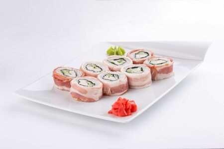 Japanese sushi roll with bacon and cheese isolated on white background side view