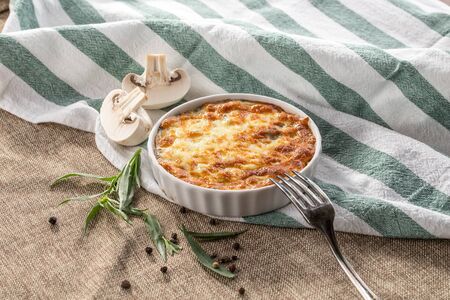 julienne with mushrooms and melted cheese on grey tablecloth side viewの写真素材