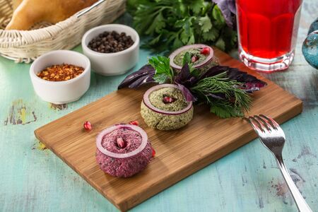 assorted pkhali traditional Georgian dish with walnut on blue wooden table side viewの写真素材