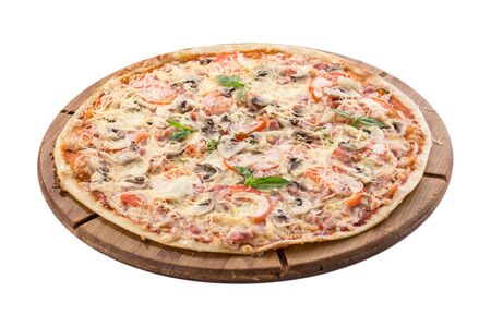 whole pizza with mushrooms, ham and cheese on wooden board isolated on white background side viewの写真素材