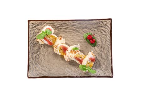 Dessert pancake Roll with Fruit and Cream Cheese and cherry isolated on white background top viewの写真素材