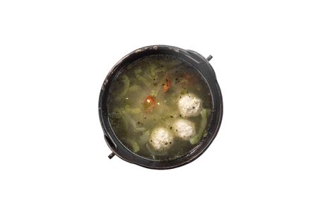 chicken broth with meatballs and chili pepper in pot isolated on white background top viewの写真素材