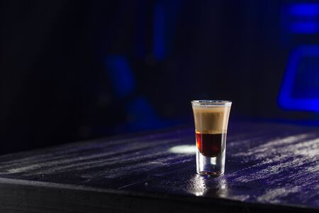 Layered Cocktail shot B 52 on the table on nightclub