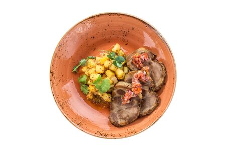 grilled pork chop neck cut with potato on orange plate isolated on white background top viewの写真素材
