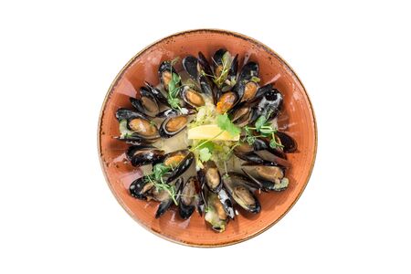 fresh mussels with cream sauce on orange plate isolated on white background top viewの写真素材