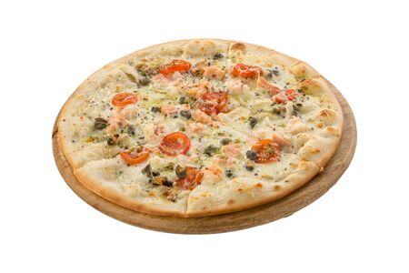 Delicious seafood pizza with salmon, capers and tomatoes on wooden board isolated on white background side viewの写真素材