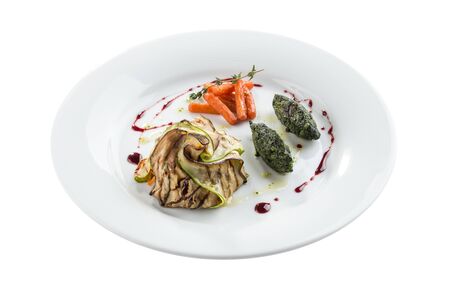 grilled vegetables eggplant, zucchini, baby carrot and spinach on white plate isolated on white background sde viewの写真素材