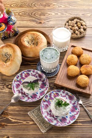 Traditional Uzbek Flat Bread With sour milk drink On wooden table side viewの写真素材