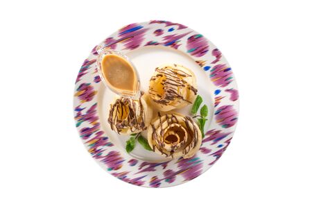 Crispy cookies Brushwood dessert with chocolate and caranel sauce on plate isolated on white background top viewの写真素材
