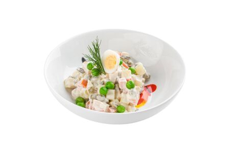 Russian traditional salad Olivier with egg and green pea isolated on white background side viewの写真素材