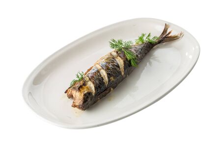 Hot smoked herring fish on white plate isolated on white background side viewの写真素材