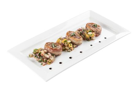 Grilled steak filet mignon wrapped bacon with potato on white plate isolated on white background side viewの写真素材
