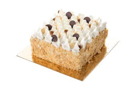 Square Sponge Cake with Whipped Cream, nuts and chocolate isolated on white background side viewの写真素材