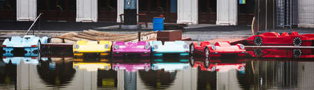Cute colorful car catamarans on the lake in the parkの写真素材